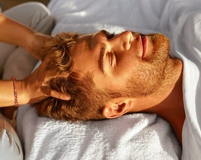 Ein Mann bei der Kopfhautmassage
