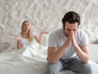 A man in bed with erection problems